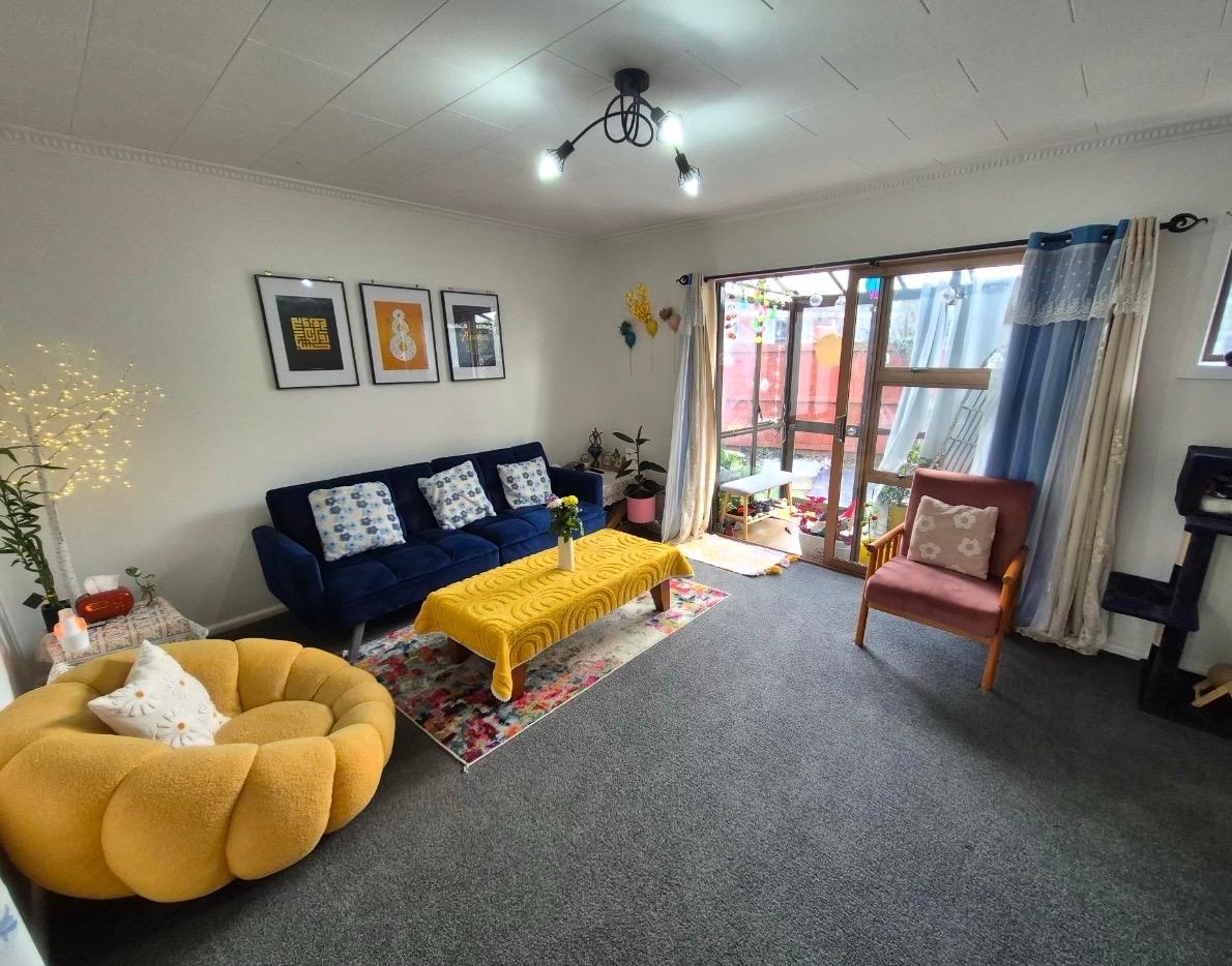 Styled living room with navy sofa and mustard chair
